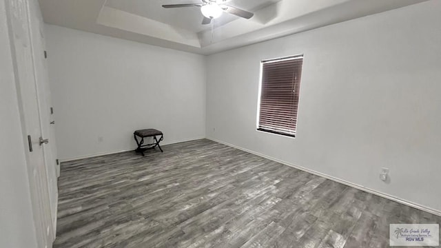 2839 Regency Dr, Brownsville, TX 78526 - unfurnished room featuring a raised ceiling, ceiling fan, wood finished floors, and baseboards