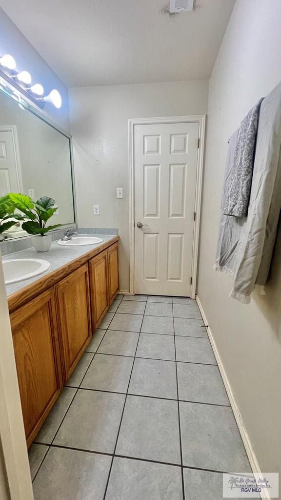 2839 Regency Dr, Brownsville, TX 78526 - full bath featuring tile patterned floors, double vanity, and baseboards