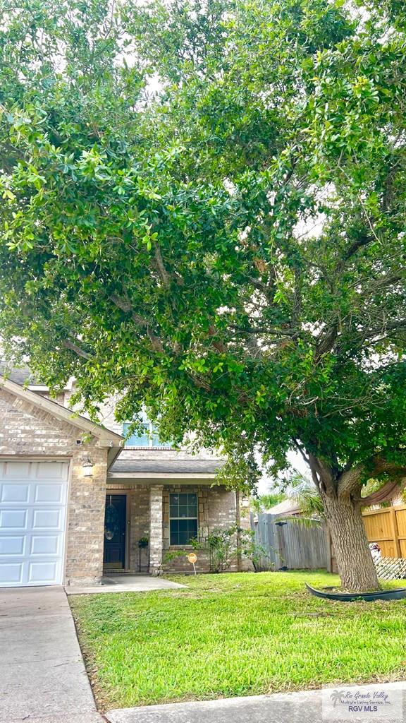 2839 Regency Dr, Brownsville, TX 78526 - view of front of home featuring brick siding, driveway, and an attached garage