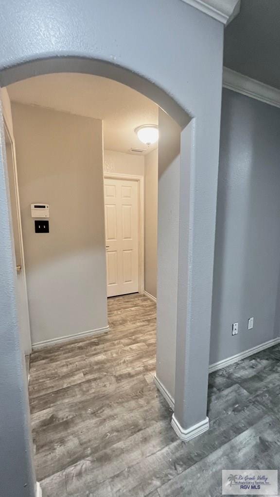 2839 Regency Dr, Brownsville, TX 78526 - hall with arched walkways, wood finished floors, ornamental molding, and baseboards