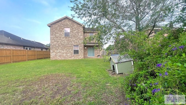 2839 Regency Dr, Brownsville, TX 78526 - rear view of house with brick siding, a shed, and an outdoor structure