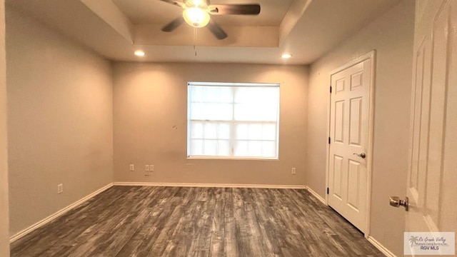 2839 Regency Dr, Brownsville, TX 78526 - empty room with baseboards, dark wood-style flooring, a ceiling fan, a raised ceiling, and recessed lighting