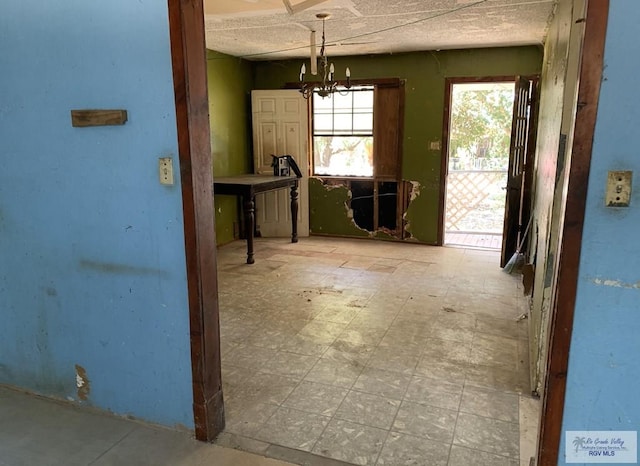 453 Sombra St, San Benito, TX 78586 - unfurnished dining area with tile patterned floors and a notable chandelier
