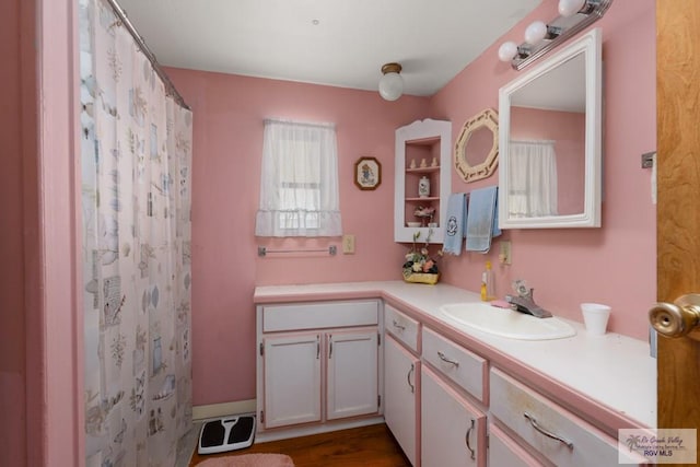 bathroom with hardwood / wood-style floors, vanity, and a shower with shower curtain