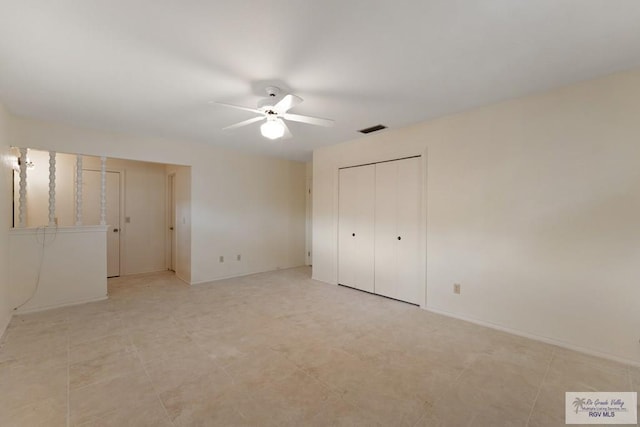 unfurnished bedroom with ceiling fan and a closet