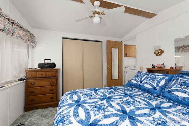 bedroom with lofted ceiling with beams, ceiling fan, a closet, and washing machine and clothes dryer