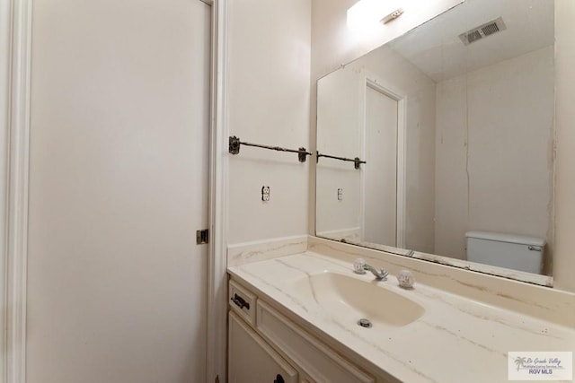 bathroom with vanity and toilet