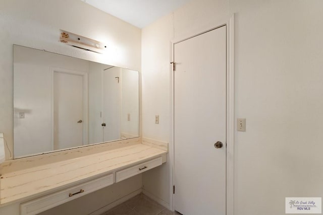 bathroom with tile patterned floors and vanity