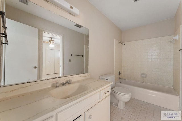 full bathroom with vanity, tiled shower / bath combo, ceiling fan, tile patterned flooring, and toilet