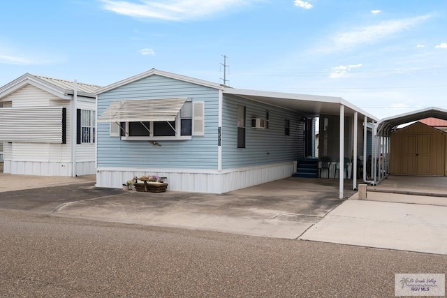 manufactured / mobile home featuring a shed and a carport