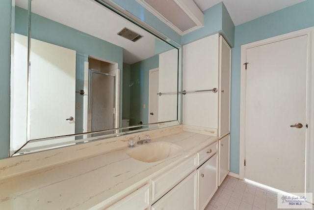 bathroom featuring tile patterned floors, vanity, an enclosed shower, and toilet