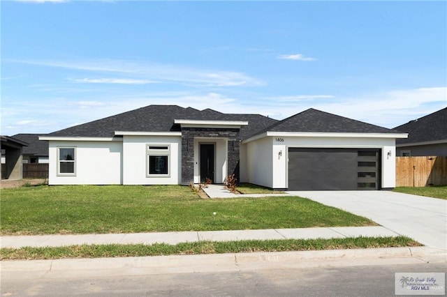 prairie-style house featuring a front lawn and a garage