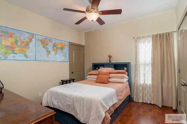 bedroom with ceiling fan and dark hardwood / wood-style floors