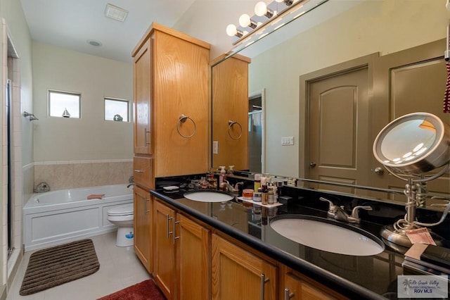 full bathroom featuring tile patterned flooring, vanity, toilet, and independent shower and bath