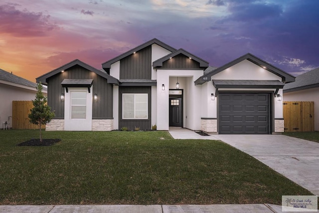 view of front of home with a garage and a yard