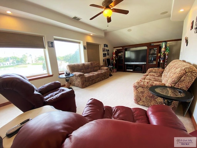 living room featuring carpet flooring, ceiling fan, and lofted ceiling