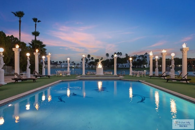 view of pool at dusk