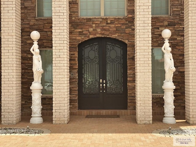 view of exterior entry featuring french doors