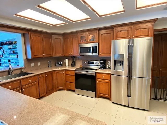 kitchen featuring light tile patterned floors, sink, and appliances with stainless steel finishes