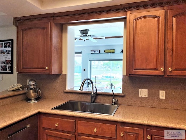 kitchen featuring tasteful backsplash, ceiling fan, and sink