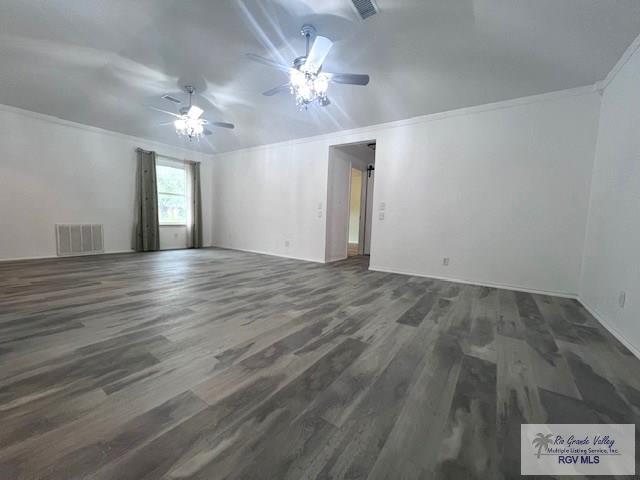 spare room with crown molding, dark hardwood / wood-style floors, and ceiling fan