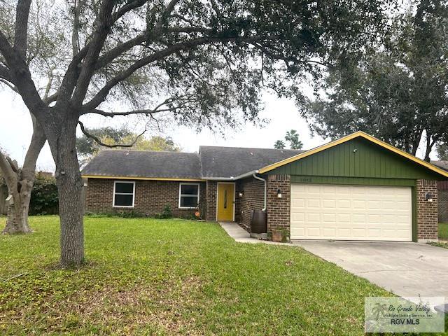 ranch-style house with a garage and a front yard