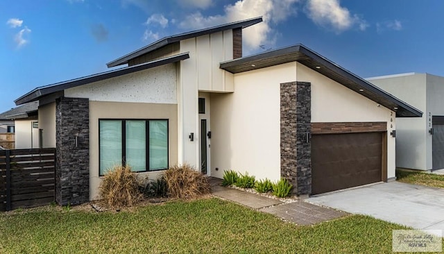 modern home featuring a garage and a front yard