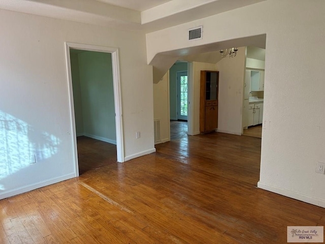 54 Shary Ave, Brownsville, TX 78521 - unfurnished room with a chandelier and hardwood / wood-style floors