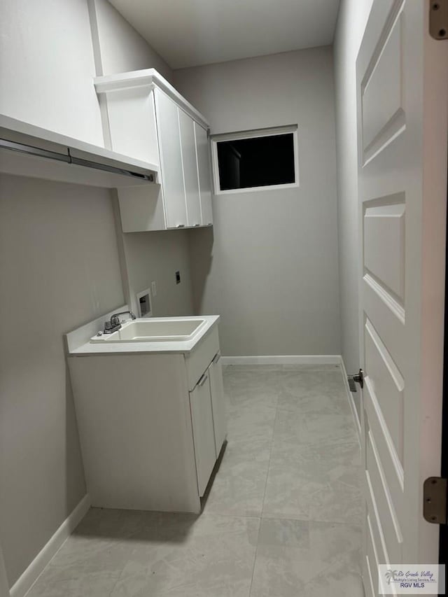 laundry area featuring hookup for an electric dryer, sink, cabinets, and washer hookup