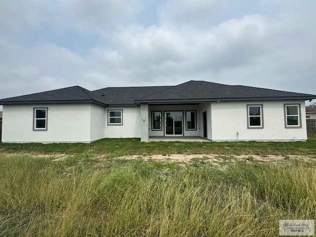 back of house with a lawn and a patio area