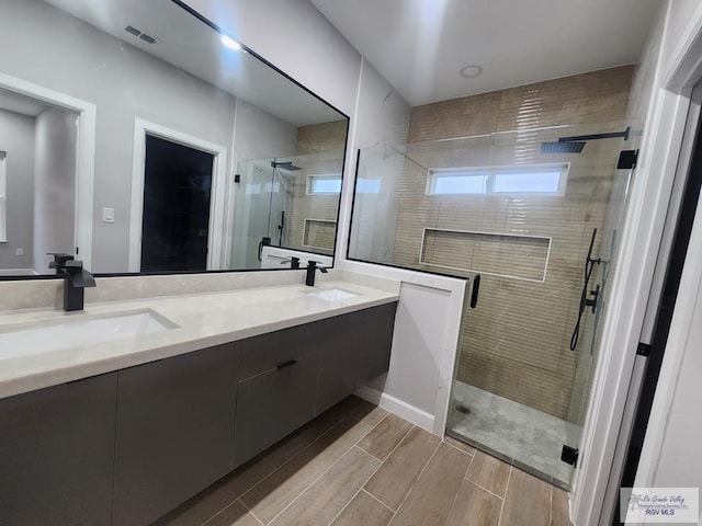 bathroom featuring an enclosed shower and vanity