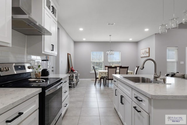 kitchen featuring stainless steel electric stove, visible vents, light tile patterned flooring, a sink, and wall chimney exhaust hood