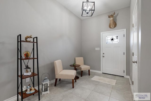 entryway with light tile patterned floors, baseboards, and a chandelier