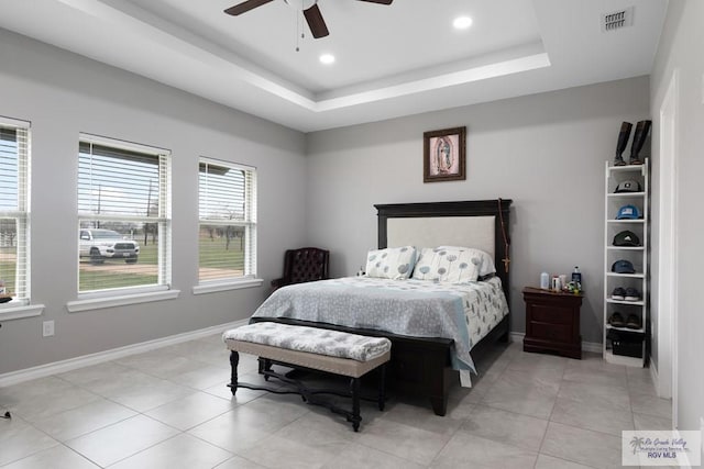 bedroom featuring light tile patterned floors, recessed lighting, visible vents, baseboards, and a raised ceiling