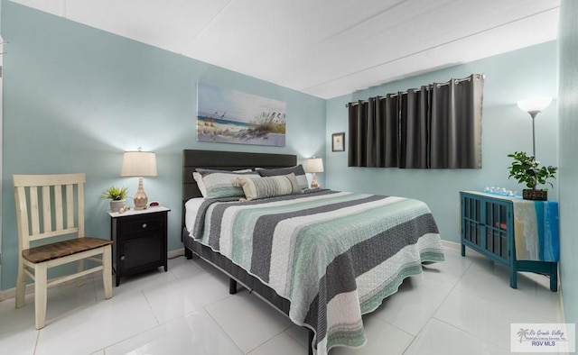 111 E Morningside Dr Unit 209, South Padre Island, TX 78597 - bedroom featuring tile patterned flooring and baseboards