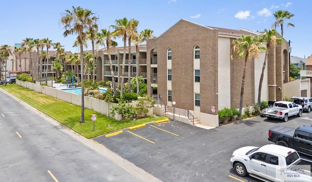 111 E Morningside Dr Unit 209, South Padre Island, TX 78597 - view of building exterior with uncovered parking
