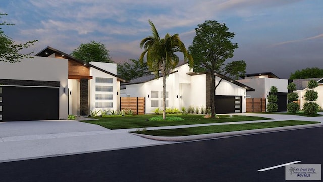 234 Cameo Dr, San Benito, TX 78586 - modern home featuring driveway, stucco siding, an attached garage, and stone siding