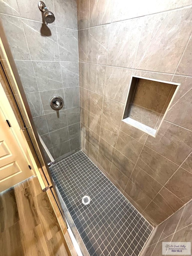 bathroom with tiled shower