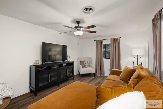 living room with a ceiling fan, wood finished floors, visible vents, and baseboards