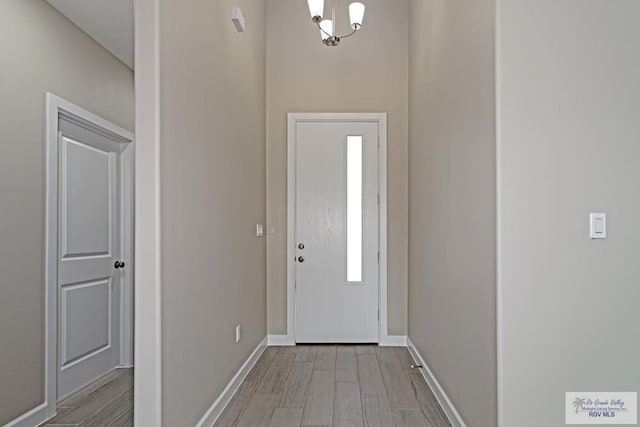 foyer featuring a chandelier and light hardwood / wood-style floors