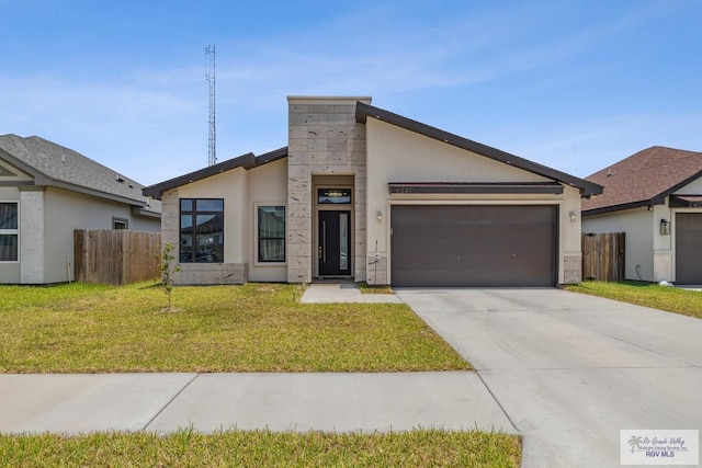 6221 Grapevine Loop, Brownsville, TX 78526 - view of front facade featuring a garage, driveway, and stucco siding