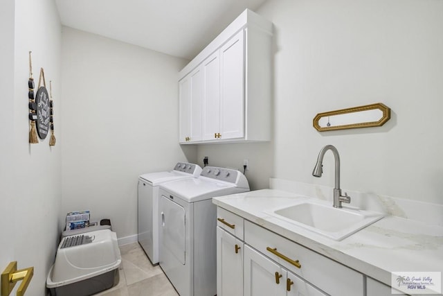 6221 Grapevine Loop, Brownsville, TX 78526 - washroom with cabinet space, washer and clothes dryer, and light tile patterned flooring