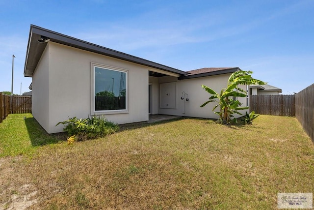 6221 Grapevine Loop, Brownsville, TX 78526 - rear view of house with stucco siding and a fenced backyard