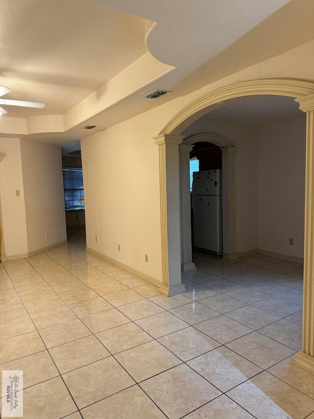 tiled empty room with ceiling fan