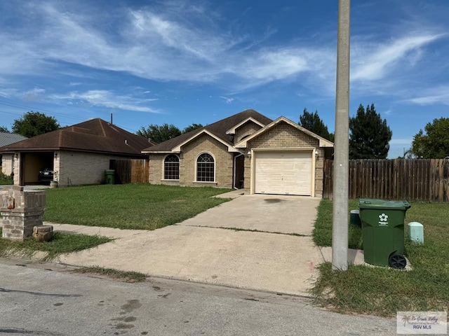 ranch-style home featuring a garage and a front lawn