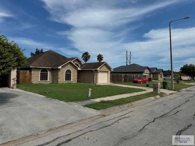 ranch-style home featuring a front lawn and a garage