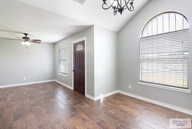 entrance foyer with baseboards, lofted ceiling, dark wood finished floors, and ceiling fan with notable chandelier