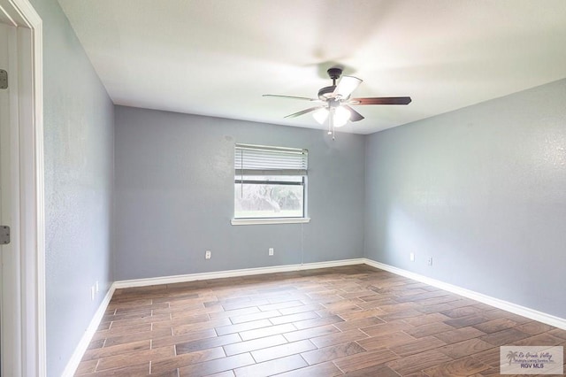 spare room with ceiling fan, baseboards, and wood finish floors