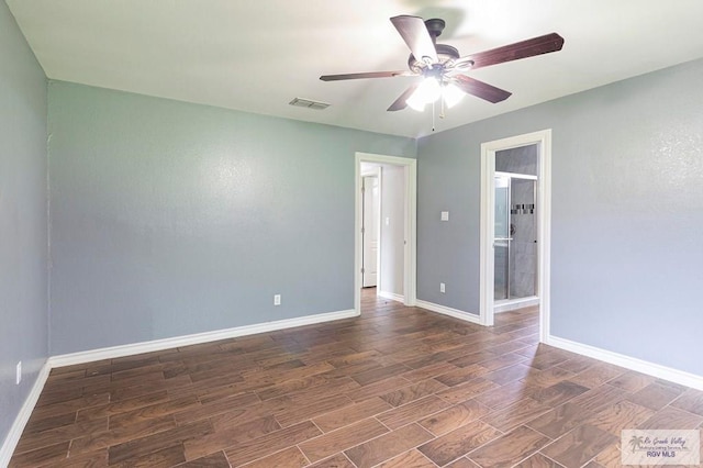 spare room with visible vents, baseboards, wood finished floors, and a ceiling fan