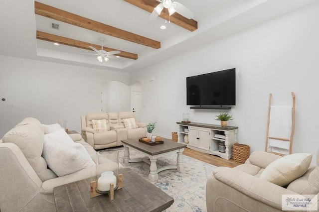 living room with beam ceiling, light hardwood / wood-style floors, and ceiling fan